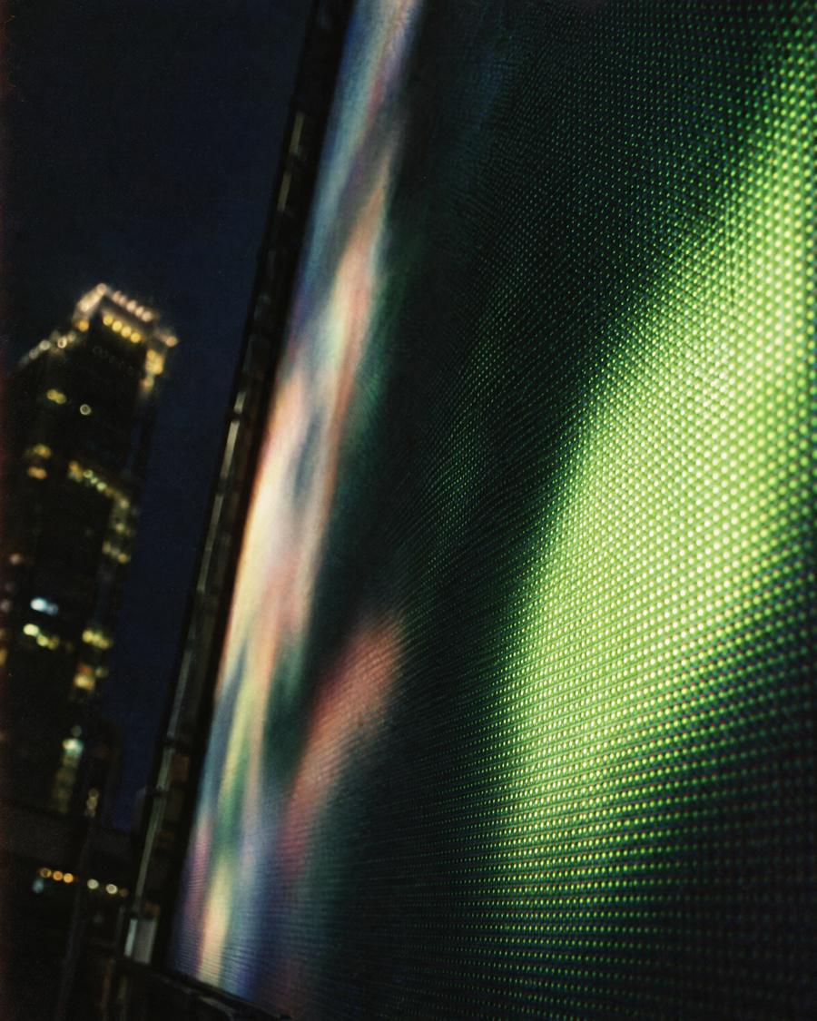 Close-up of a large LED advertising screen at night in Hong Kong